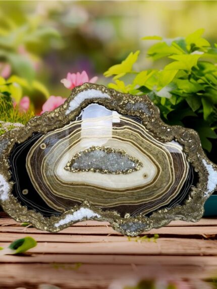 Add a touch of elegance and natural beauty to your space with this stunning geode resin wall art . Handcrafted with precision, this functional piece of art features swirling layers of epoxy resin in brown, shimmering gold, and pearlescent white, meticulously designed to mimic the intricate patterns of natural geodes. Accentuated with glittering glass crystals and metallic pigments, the wall piece face gleams with a luxurious finish, creating a captivating focal point for any room. Each piece is uniquely crafted, making it a truly one-of-a-kind addition to your home or office décor."https://saashi.co.in/wp-content/uploads/2024/09/Agate_epoxy_geode_wall_clock_31.jpg