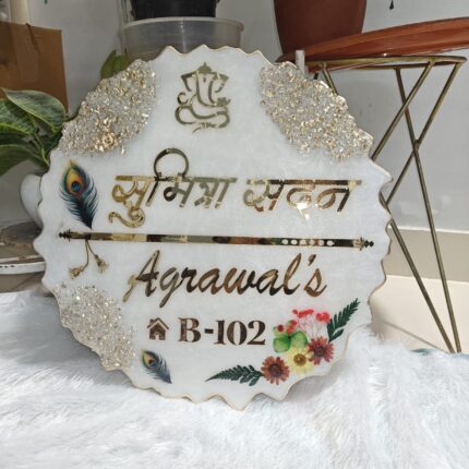 Handcrafted resin nameplate for home entrance – personalized with family name and floral design Custom epoxy resin nameplate with gold flakes and wooden base for house decor Elegant resin name board with marble texture and engraved couple names Personalized resin nameplate for main door with 3D flowers and metallic finish Unique handmade resin nameplate with modern calligraphy and glossy finish