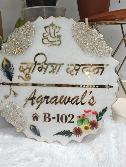 Handcrafted resin nameplate for home entrance – personalized with family name and floral design Custom epoxy resin nameplate with gold flakes and wooden base for house decor Elegant resin name board with marble texture and engraved couple names Personalized resin nameplate for main door with 3D flowers and metallic finish Unique handmade resin nameplate with modern calligraphy and glossy finish