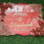 Handcrafted resin nameplate for home entrance – personalized with family name and floral design Custom epoxy resin nameplate with gold flakes and wooden base for house decor Elegant resin name board with marble texture and engraved couple names Personalized resin nameplate for main door with 3D flowers and metallic finish Unique handmade resin nameplate with modern calligraphy and glossy finish