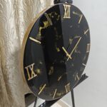 "A stylish resin wall clock featuring a black and gold color palette, perfect for modern and luxurious interiors."