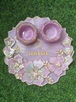 "A 10-inch resin pooja platter with intricate designs, glossy finish, and compartments for pooja essentials like diya and incense."