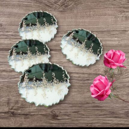 "Handcrafted black and silver resin coasters featuring ocean-inspired designs, ideal for modern and elegant table settings."