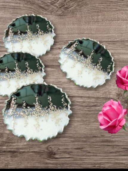 "Handcrafted black and silver resin coasters featuring ocean-inspired designs, ideal for modern and elegant table settings."