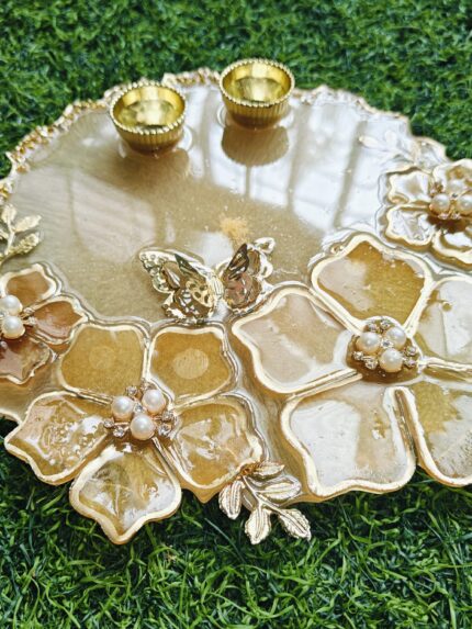 Handcrafted resin pooja platter with decorative design Artistic resin thali for religious rituals and festivals Round resin pooja plate with embedded flowers and gold accents