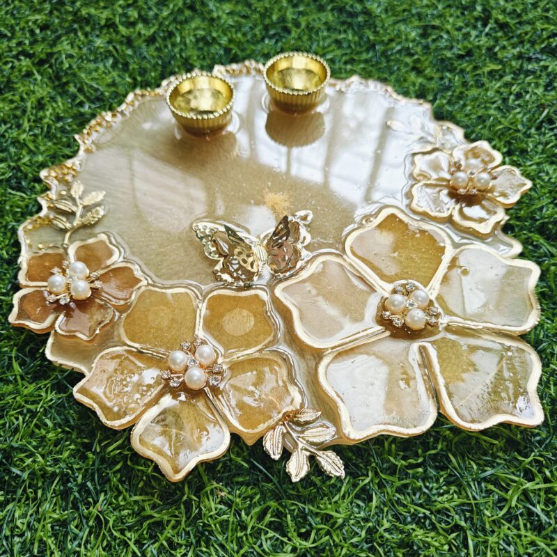 Handcrafted resin pooja platter with decorative design Artistic resin thali for religious rituals and festivals Round resin pooja plate with embedded flowers and gold accents