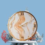 "Golden Sands resin wall clock with marble swirl design and gold Roman numerals"